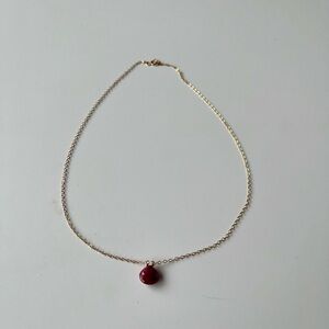 Gold necklace with red pendant